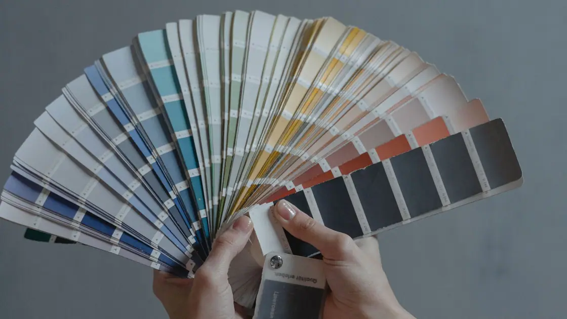 Hands fanning out a colour swatch book