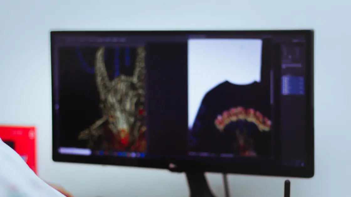 Designer working on artwork with a pen tablet and monitor