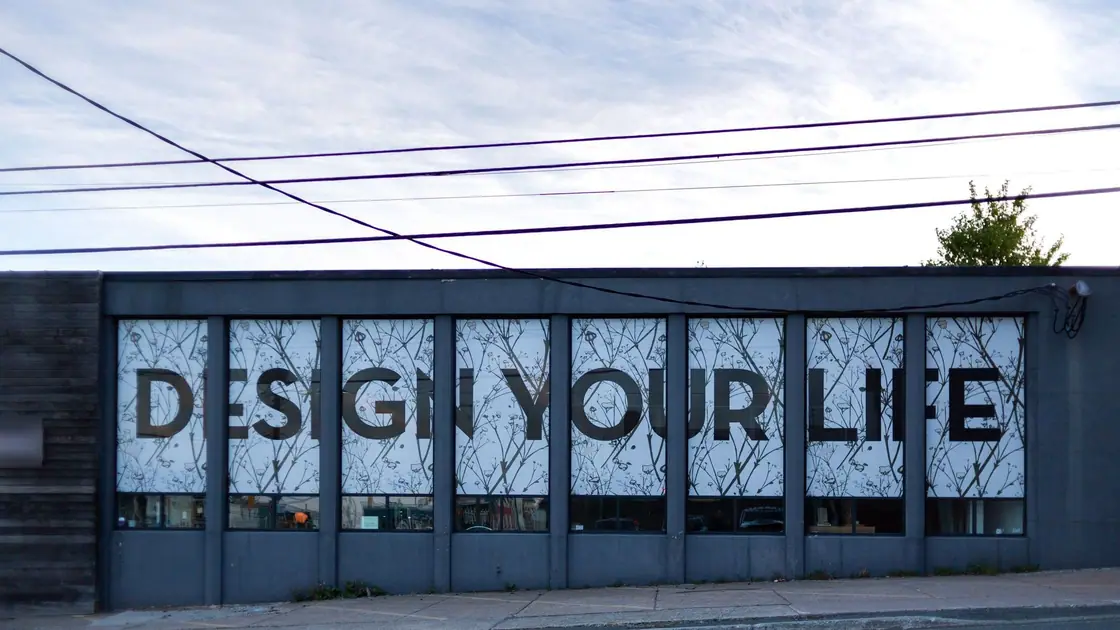 Storefront windows covered in a large lettered graphic