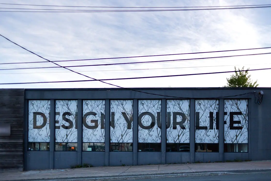 Storefront windows covered in a large lettered graphic