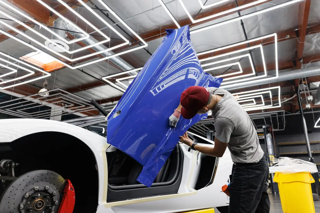 Fitting wrap vinyl to a car door photograph