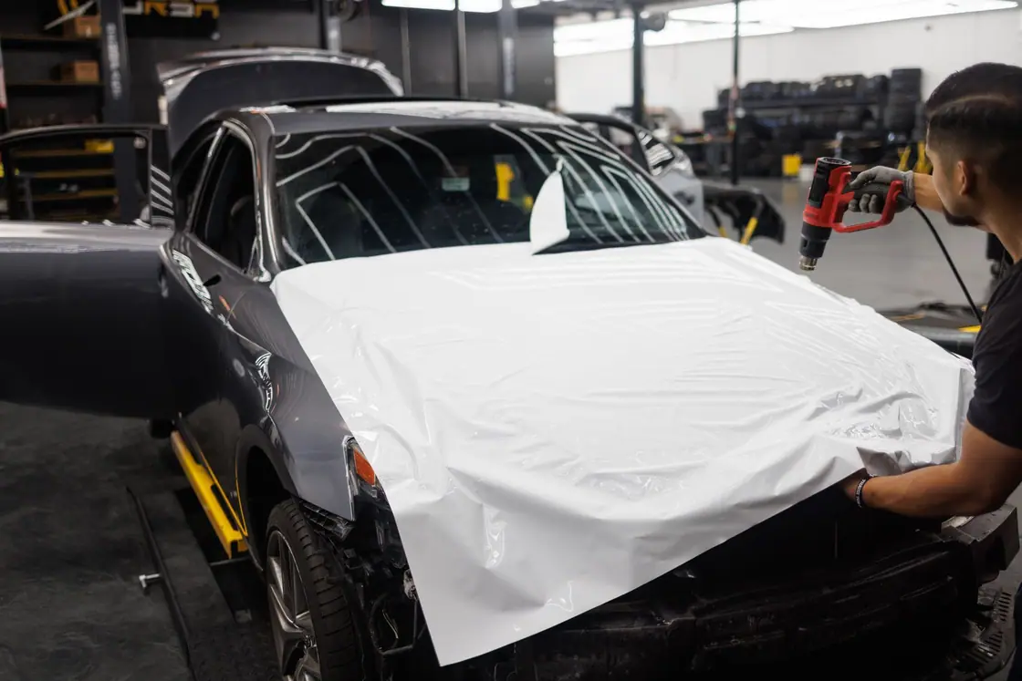 Car being wrapped in white photograph
